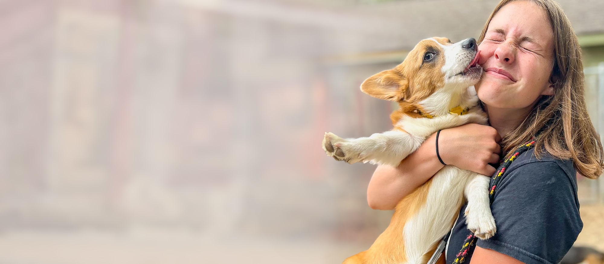 Employee enjoying some snuggles with a happy pup